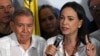 Venezuelan opposition leader Maria Corina Machado talks to the media next to opposition presidential candidate Edmundo Gonzalez Urrutia, following the presidential election results in Caracas on July 29, 2024.