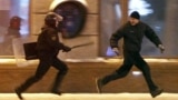 Belarus -- A riot policeman chases an opposition protester during a rally denouncing the results of presidential elections in central Minsk, 19Dec2010