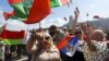 BELARUS – Supporters of Belarusian President Alexander Lukashenko hold Belarusian State Flags, as some of them wave a Russian national flag during a rally at Independent Square of Minsk, August 16, 2020